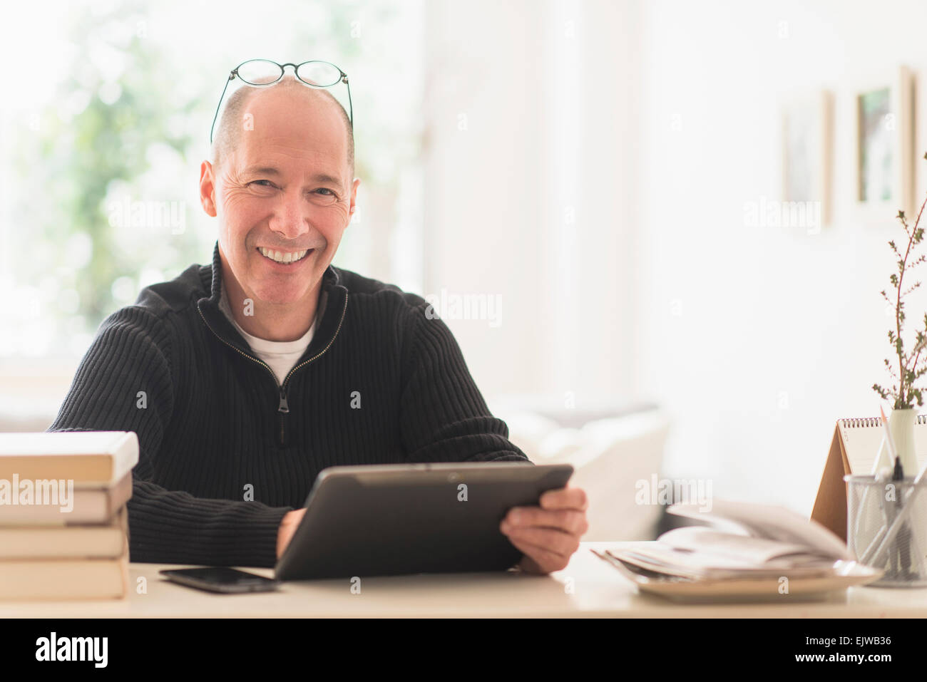 Portrait of smiling mature man working in home office Stock Photo