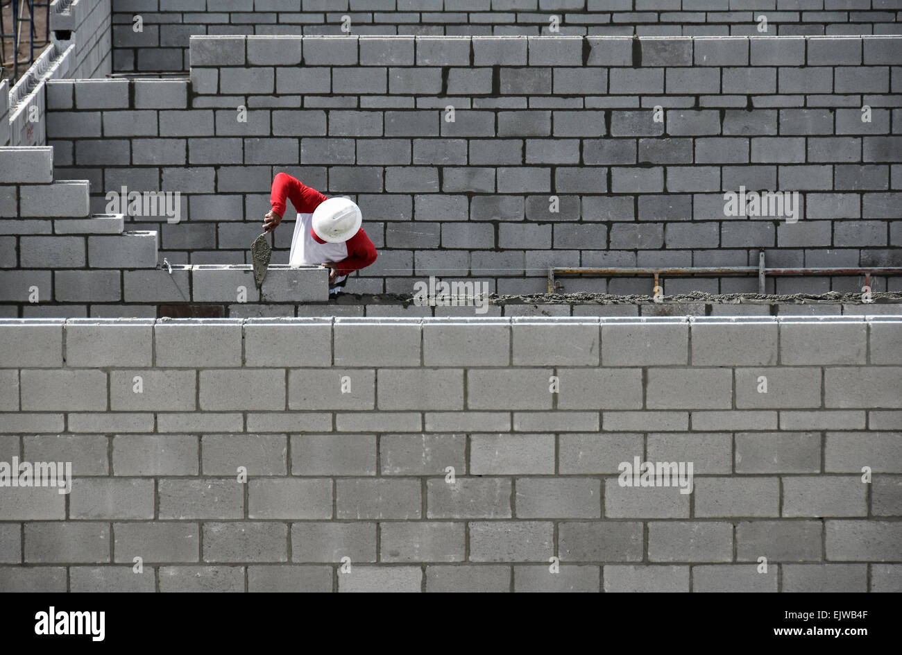 Bricklayer working on brick wall Stock Photo