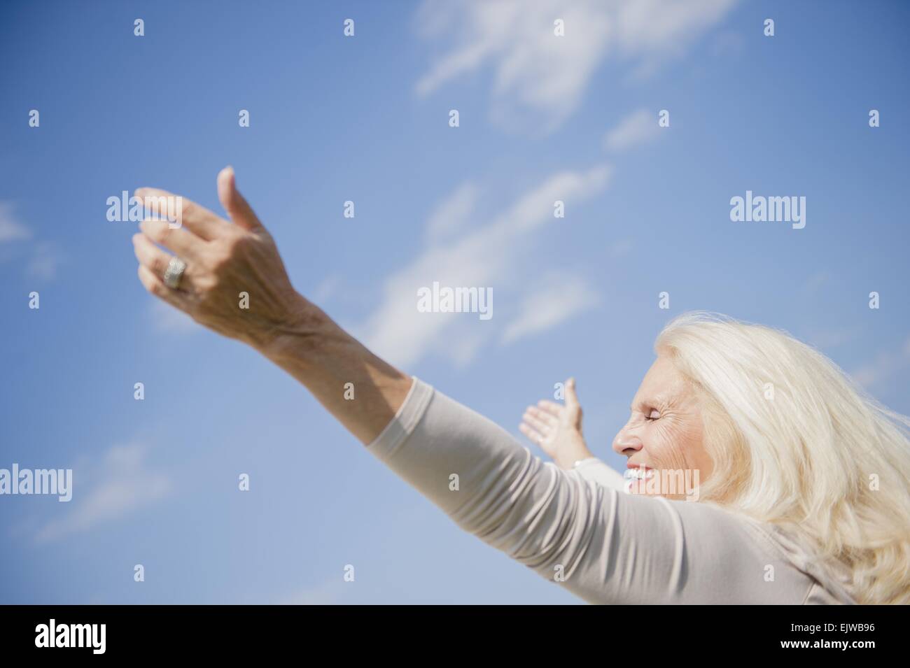 Senior woman arms outstretched hi-res stock photography and images - Alamy