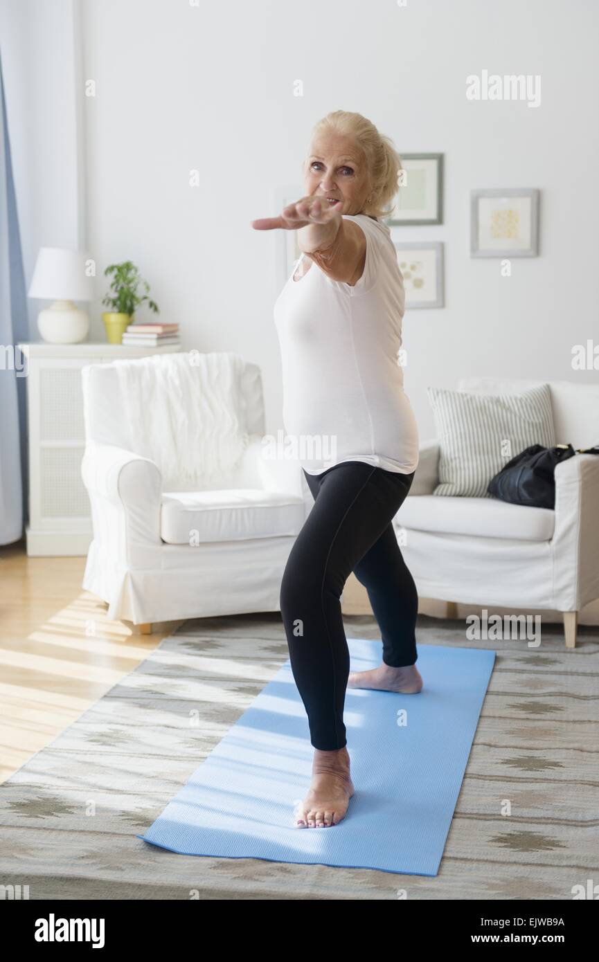 Portrait of senior woman doing yoga Stock Photo