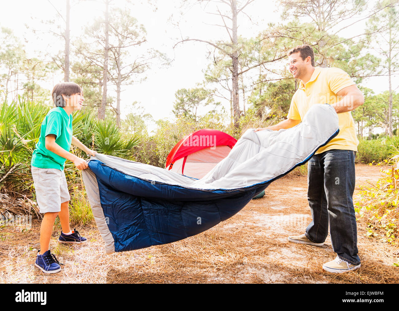 USA, Florida, Jupiter, Father and son (1213) preparing sleeping bag