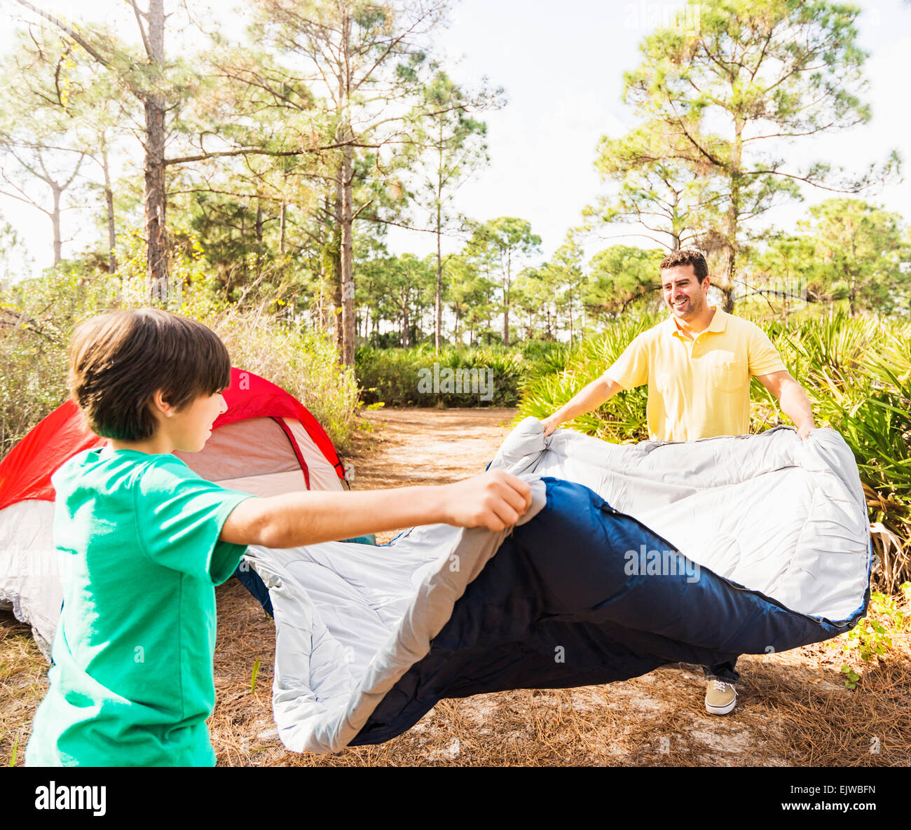 USA, Florida, Jupiter, Father and son (1213) preparing sleeping bag