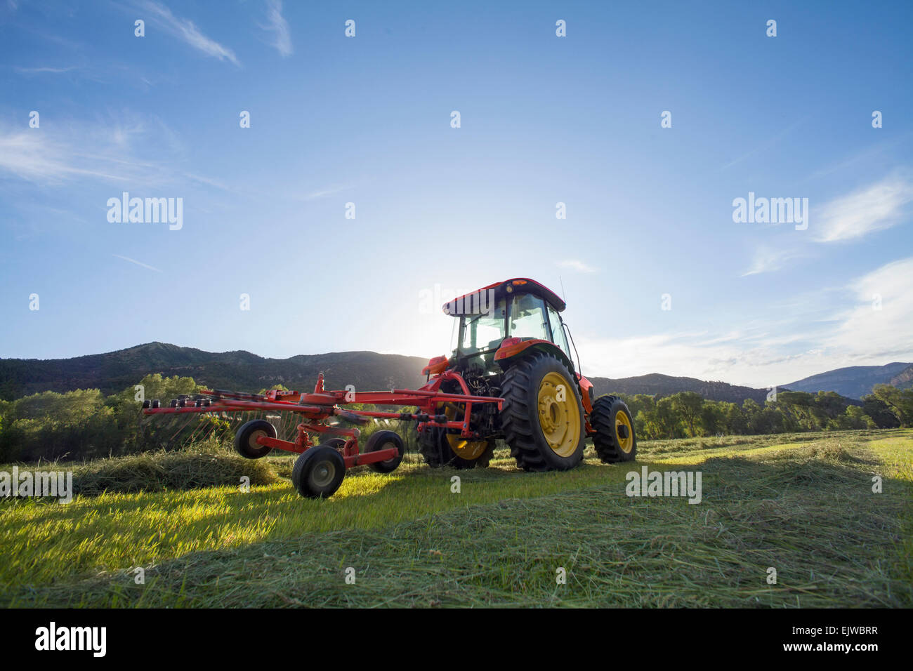 USA, Colorado, Tractor in field at sunset Stock Photo Alamy