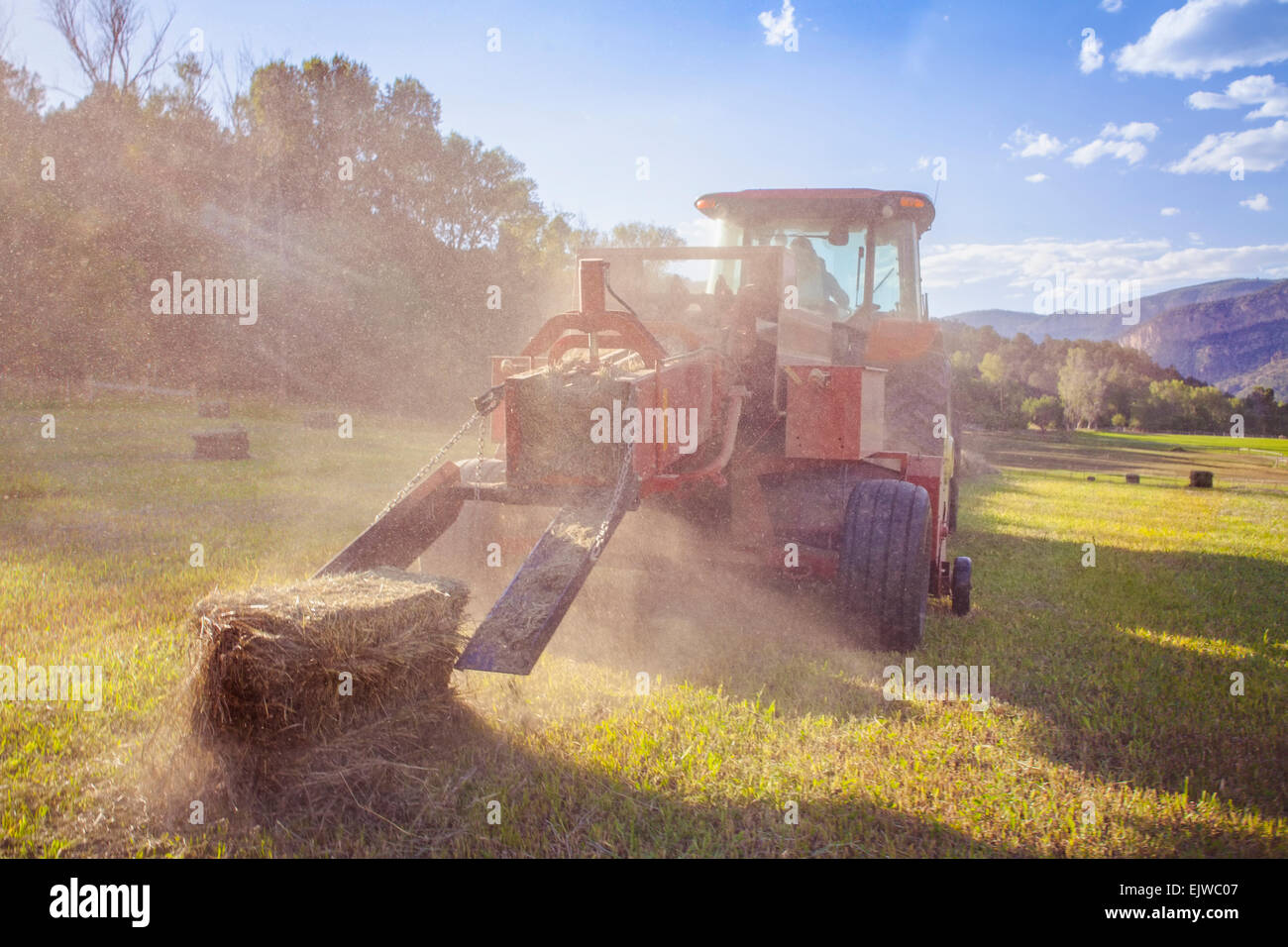 USA, Colorado, Tractor in field at sunset Stock Photo Alamy