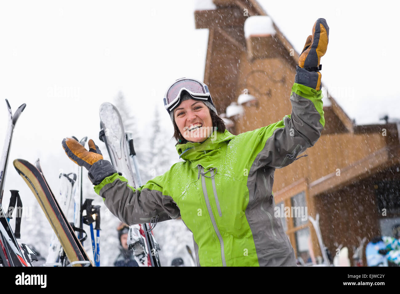 USA, Montana, Whitefish, Woman wearing ski googles with hands raised Stock Photo