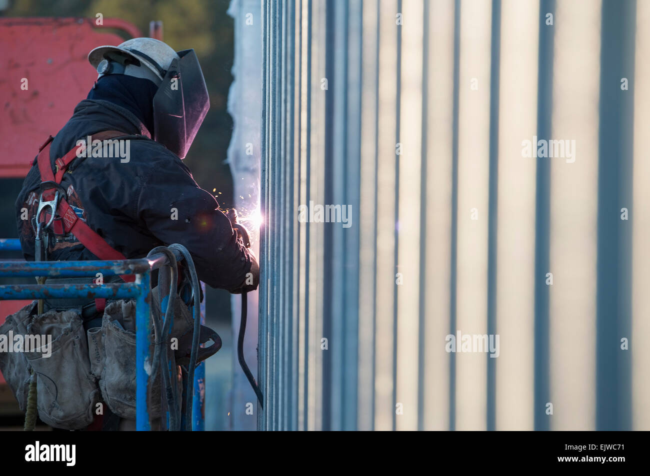 USA, Montana, Kalispell, Man welding steel bar Stock Photo