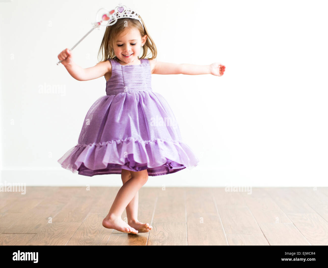 Girl (4-5) in princess costume dancing Stock Photo