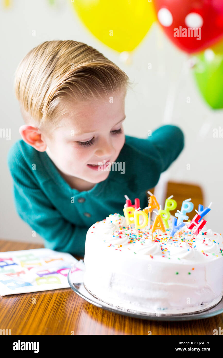Boy (2-3) looking at birthday cake Stock Photo - Alamy