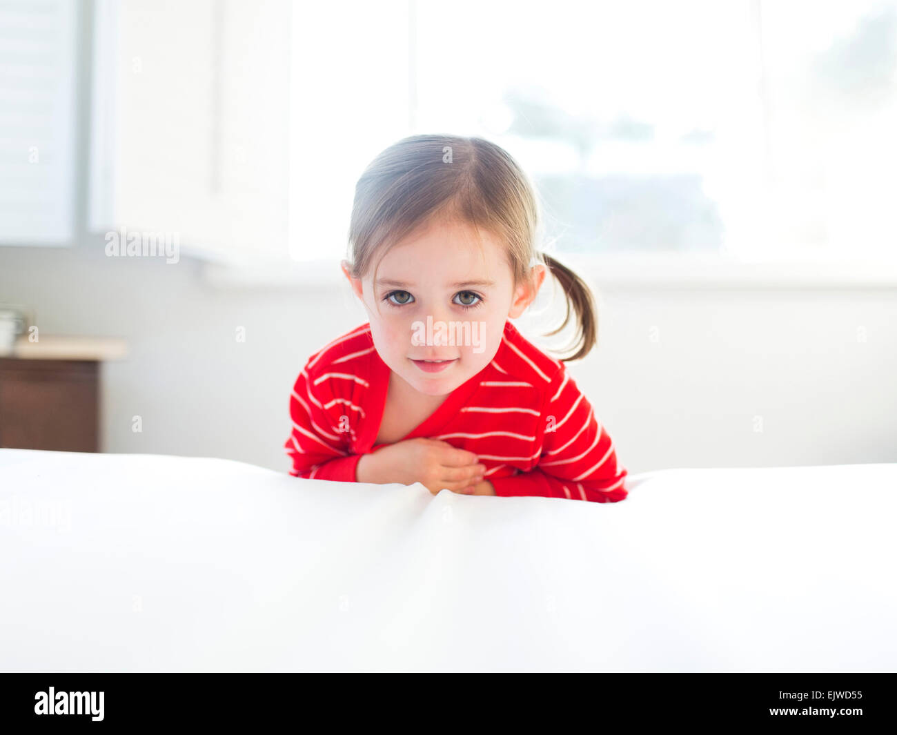 Girl (45) leaning on bed Stock Photo Alamy