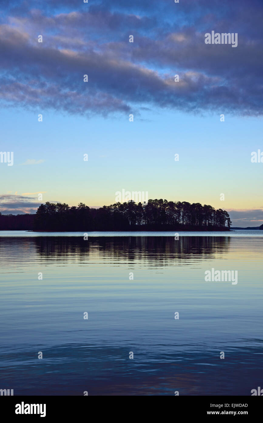 USA, Georgia, Lake Lanier, Symmetrical view of trees reflecting in lake at dusk Stock Photo