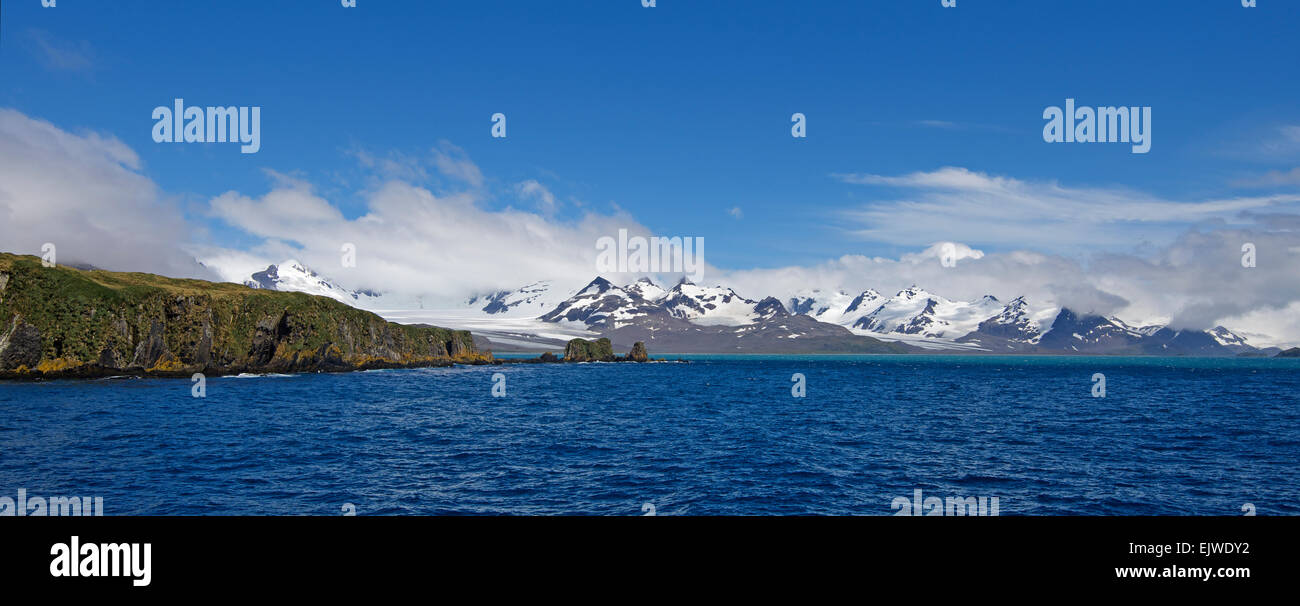 Curated visual reference: Visual Reference: Panoramic View With Snow Capped Mountains Rugged Northern Coastline