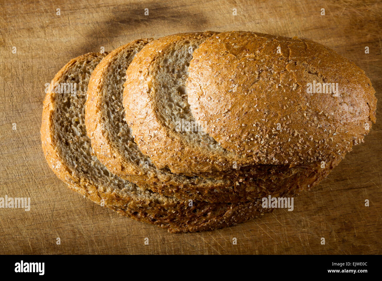 Rustic loaf. Shallow DoF, focus on the bread slices Stock Photo