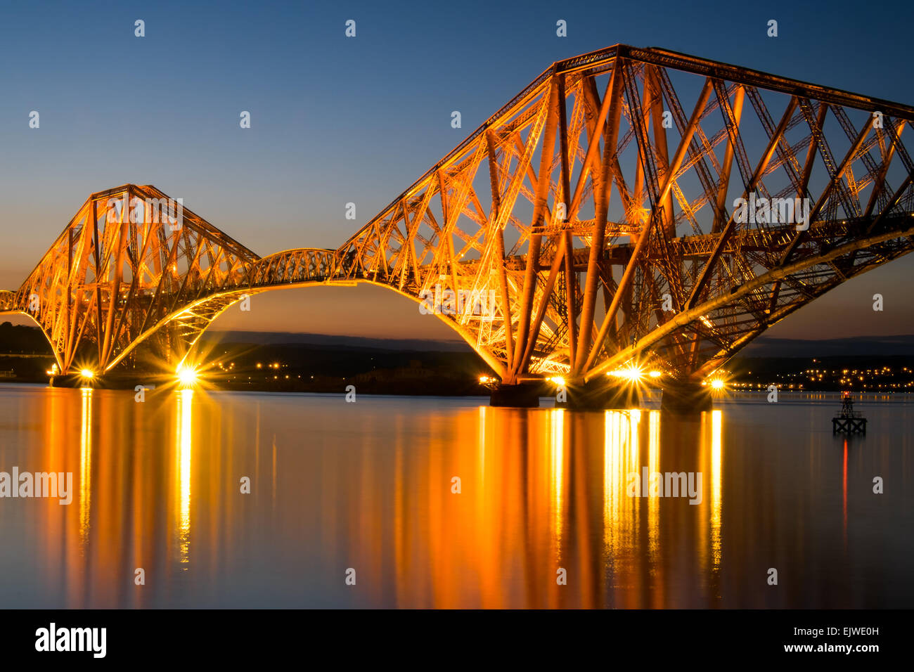 The famous Forth rail bridge illuminated at dawn Stock Photo
