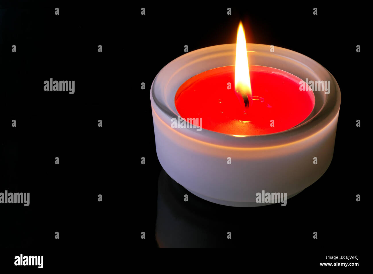Red lighted candle in black background Stock Photo Alamy