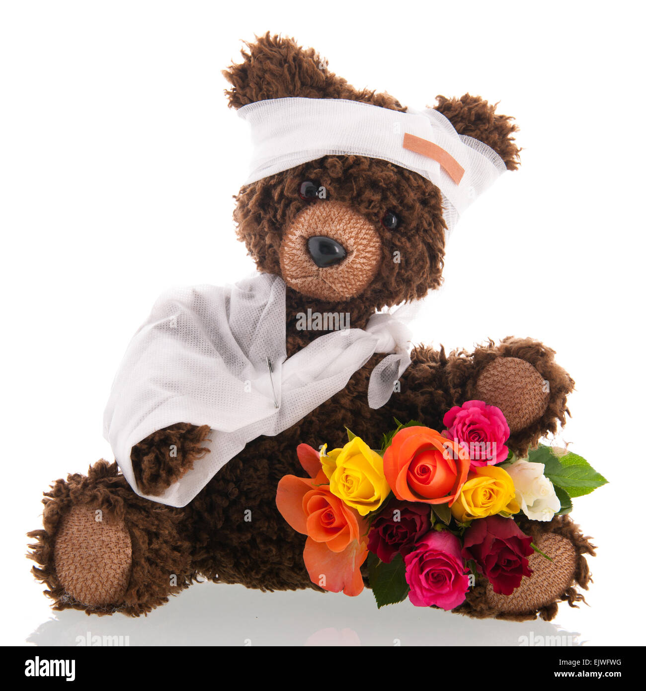 Stuffed hand made poorly bear with plaster and flowers for 'Get well soon' isolated over white background Stock Photo
