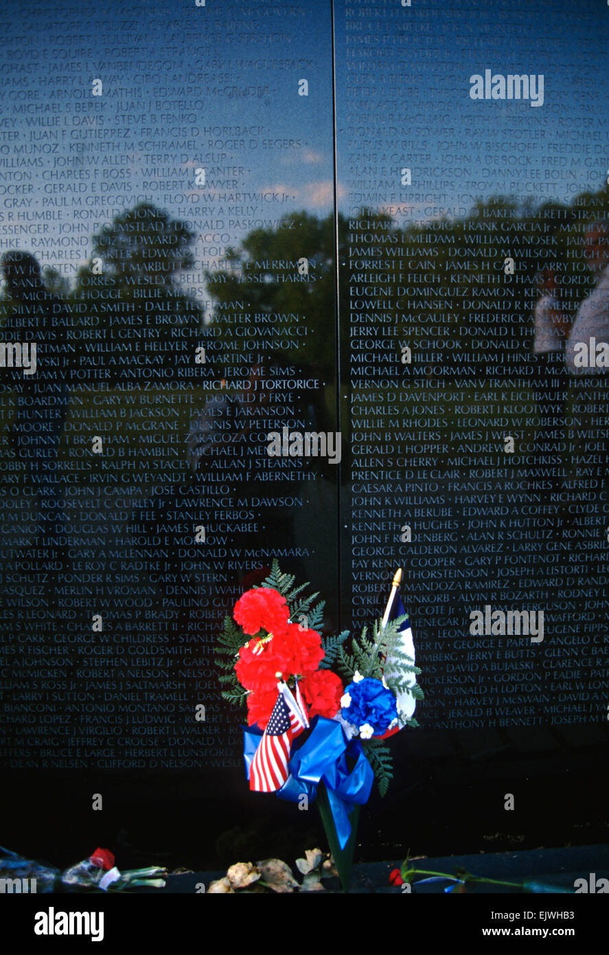 A bunch of flowers rests in memory at the Vietnam Veterans Memorial wall November 11, 1996 in Washington, DC. Stock Photo