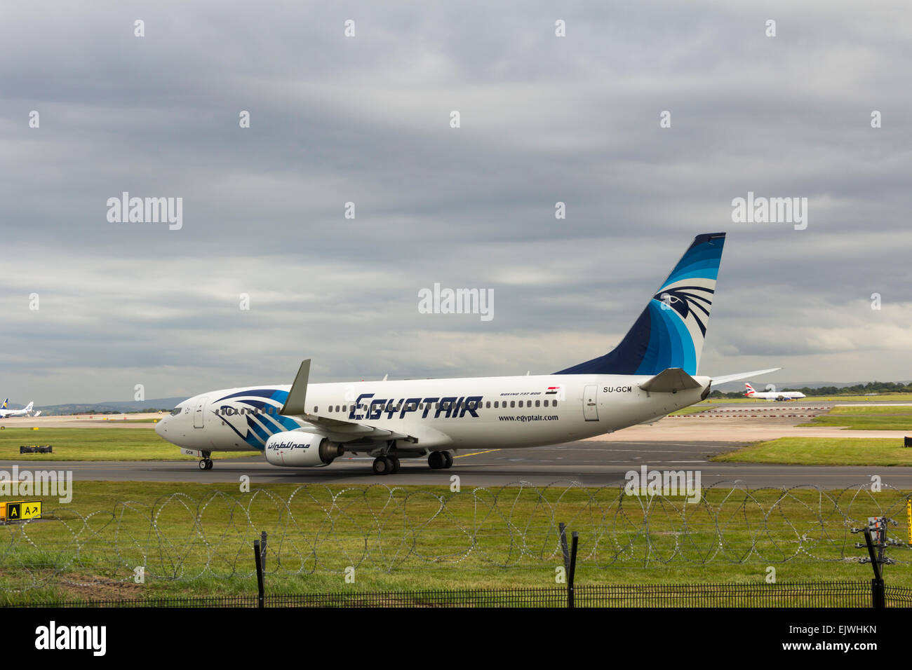 Egyptair branded Boeing 737-800 aircraft taxiing towards the take-off runway at Manchester airport. Stock Photo