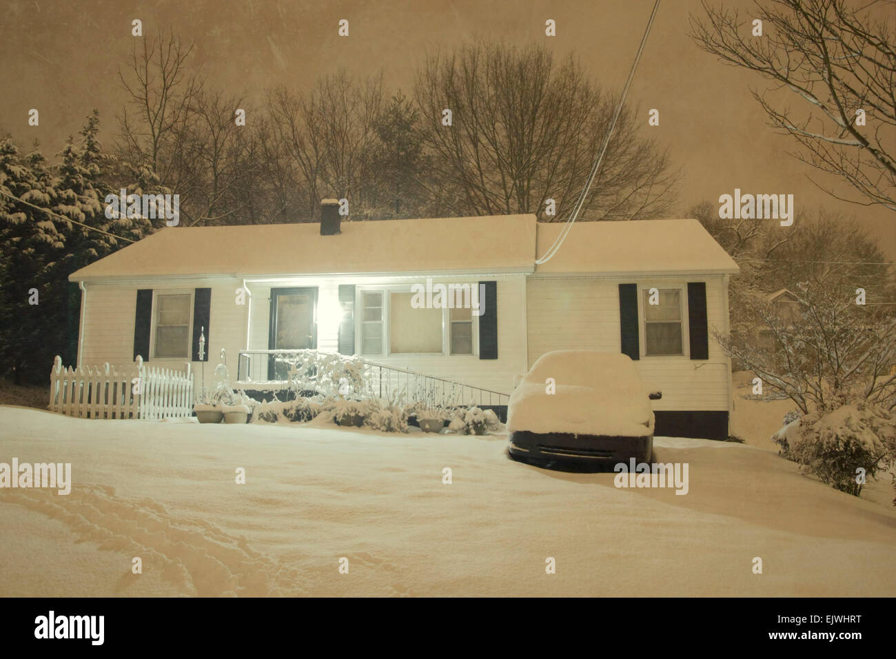 A nighttime shot of a house while it's snowing. Stock Photo