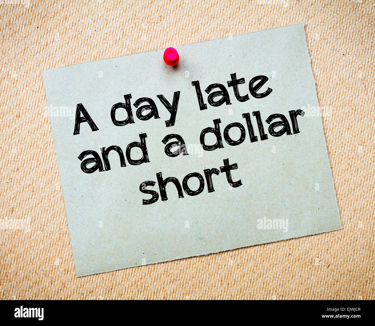 A day late and a dollar short Message. Recycled paper note pinned on cork board. Concept Image Stock Photo