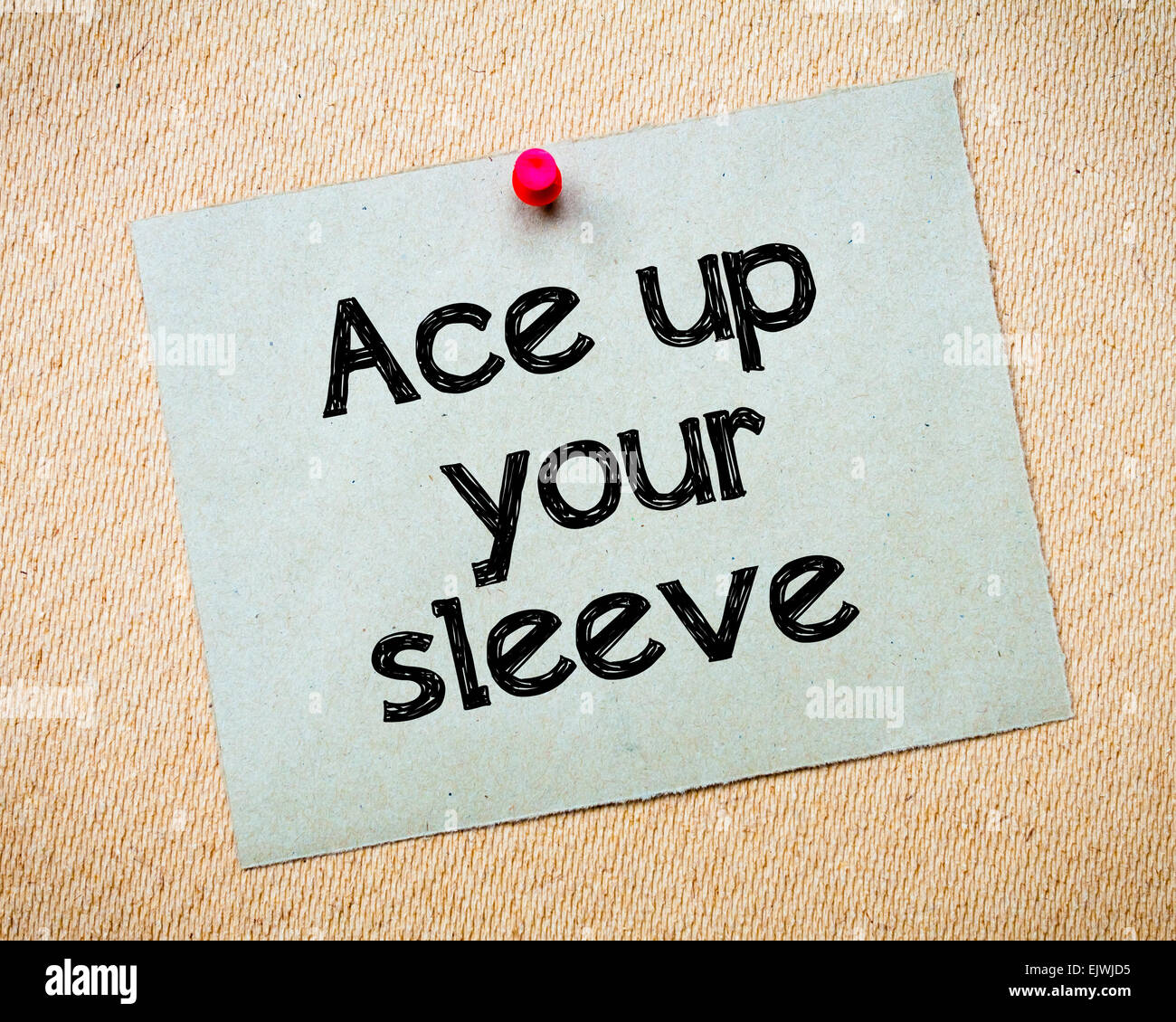Ace up your sleeve Message. Recycled paper note pinned on cork board