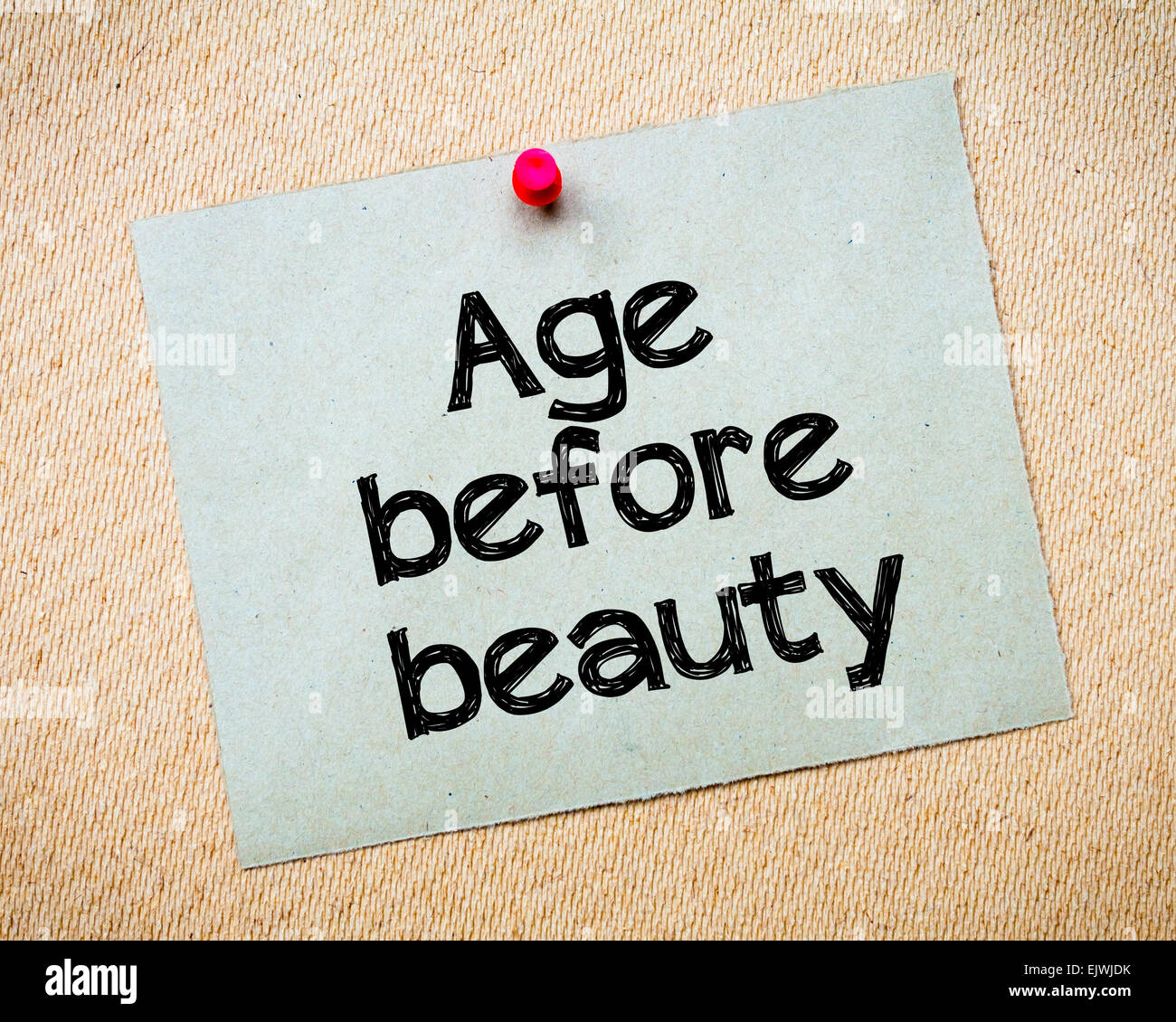 Age before beauty Message. Recycled paper note pinned on cork board. Concept Image Stock Photo