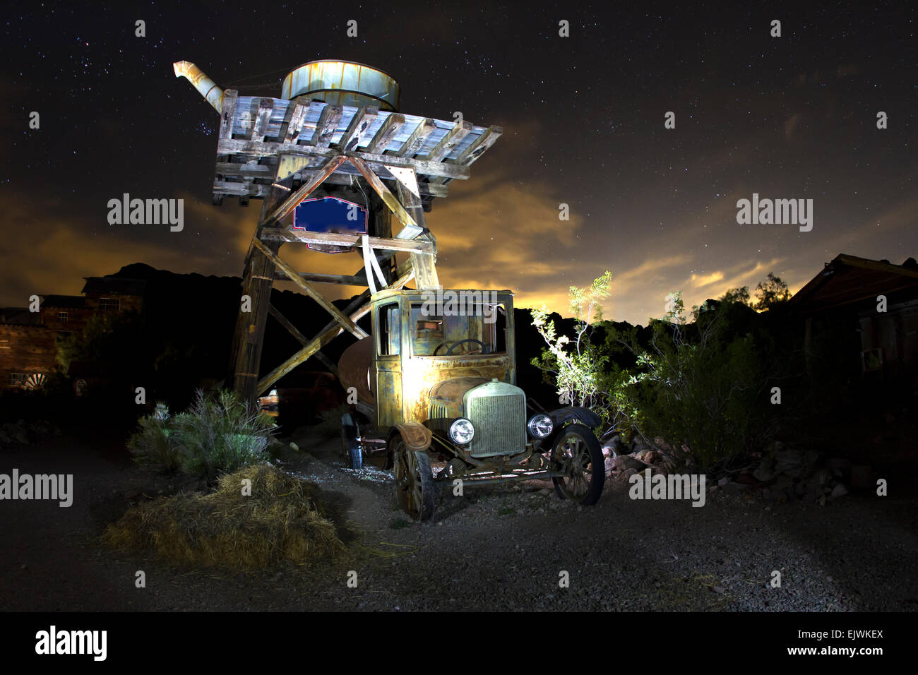 Antique car under water tower in ghost town on a starry night Stock ...