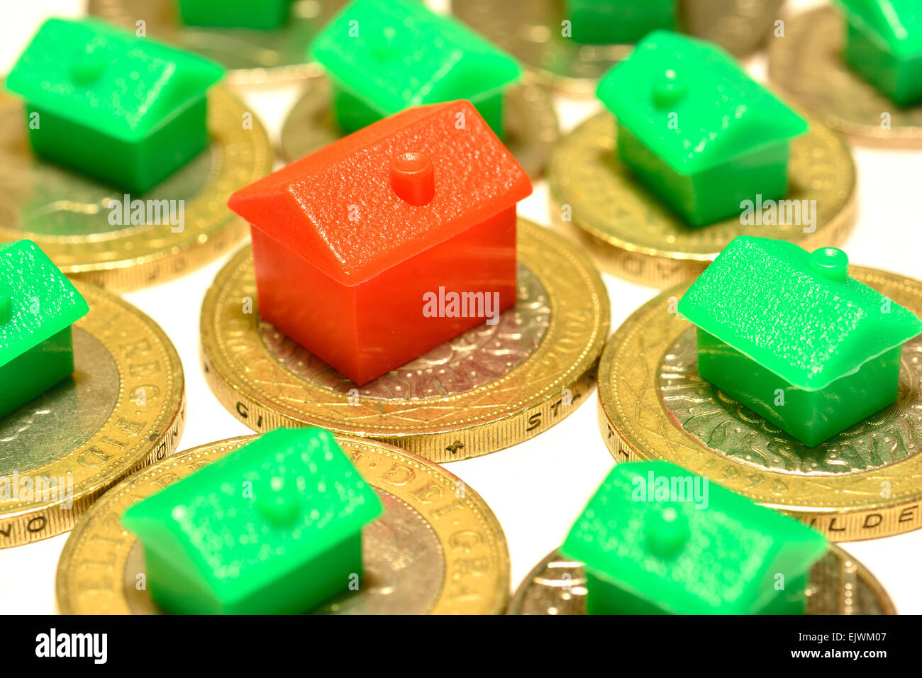 monopoly houses & hotel on coins, Property Market House buying concept Stock Photo