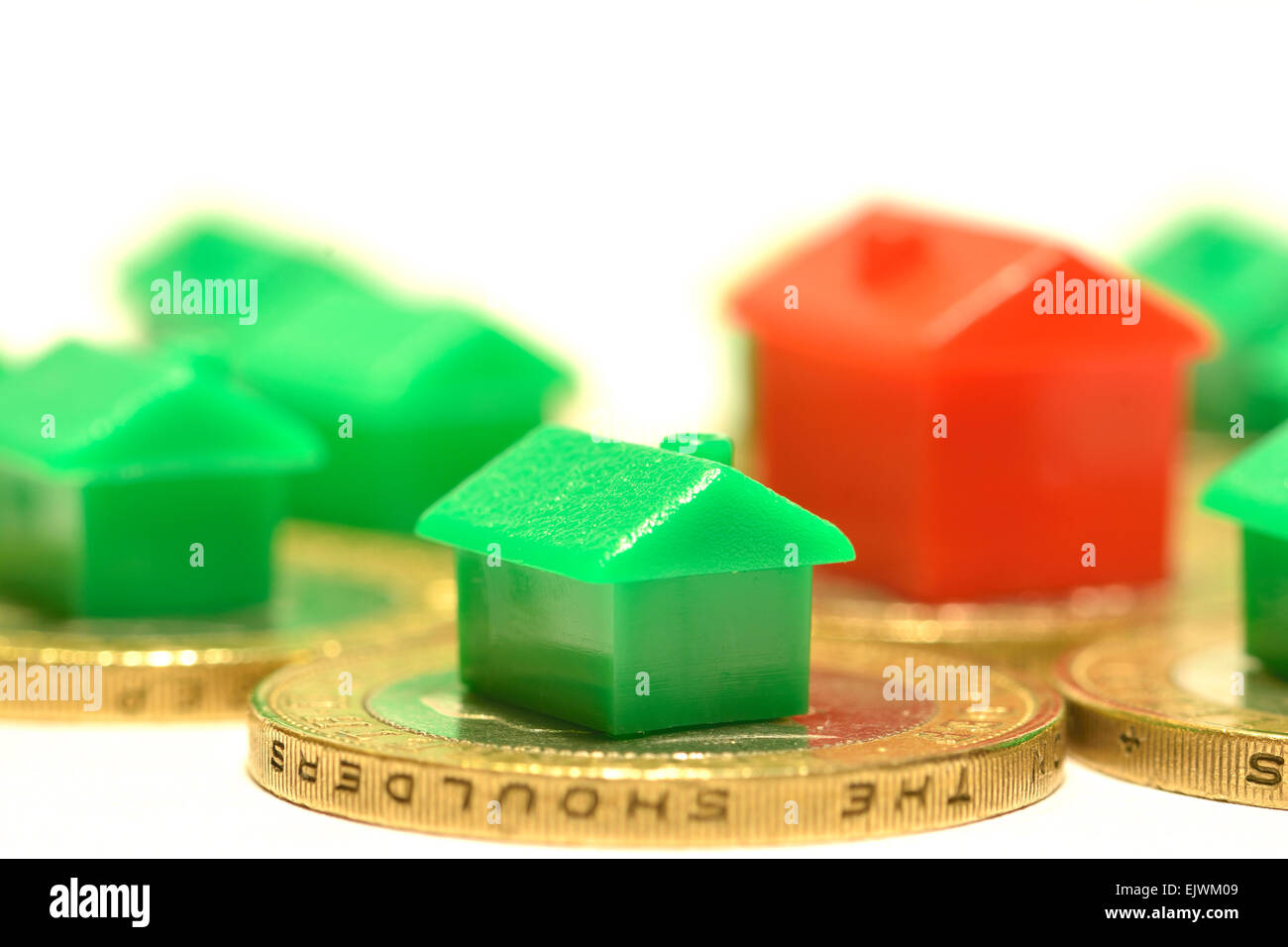 monopoly houses & hotel on coins, Property Market House buying concept Stock Photo