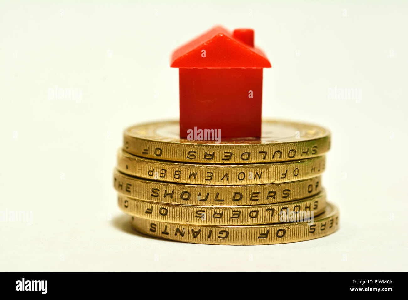 monopoly hotel on stack of two pound coins, Property Market House buying concept Stock Photo