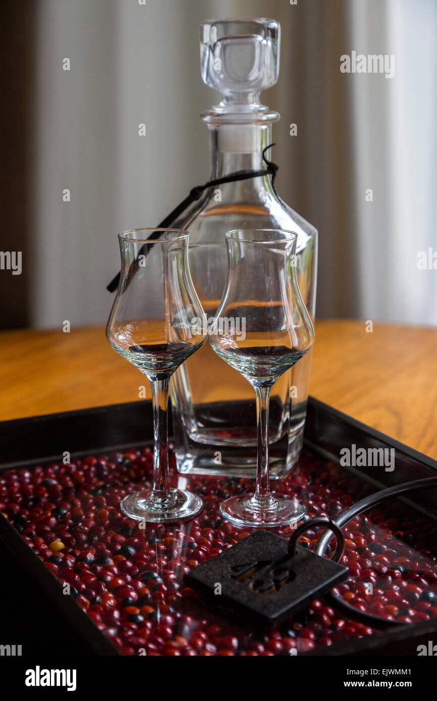 Peru, Machu Picchu Pueblo.  Pisco Brandy in Decanter with Glasses and Room Key. Stock Photo
