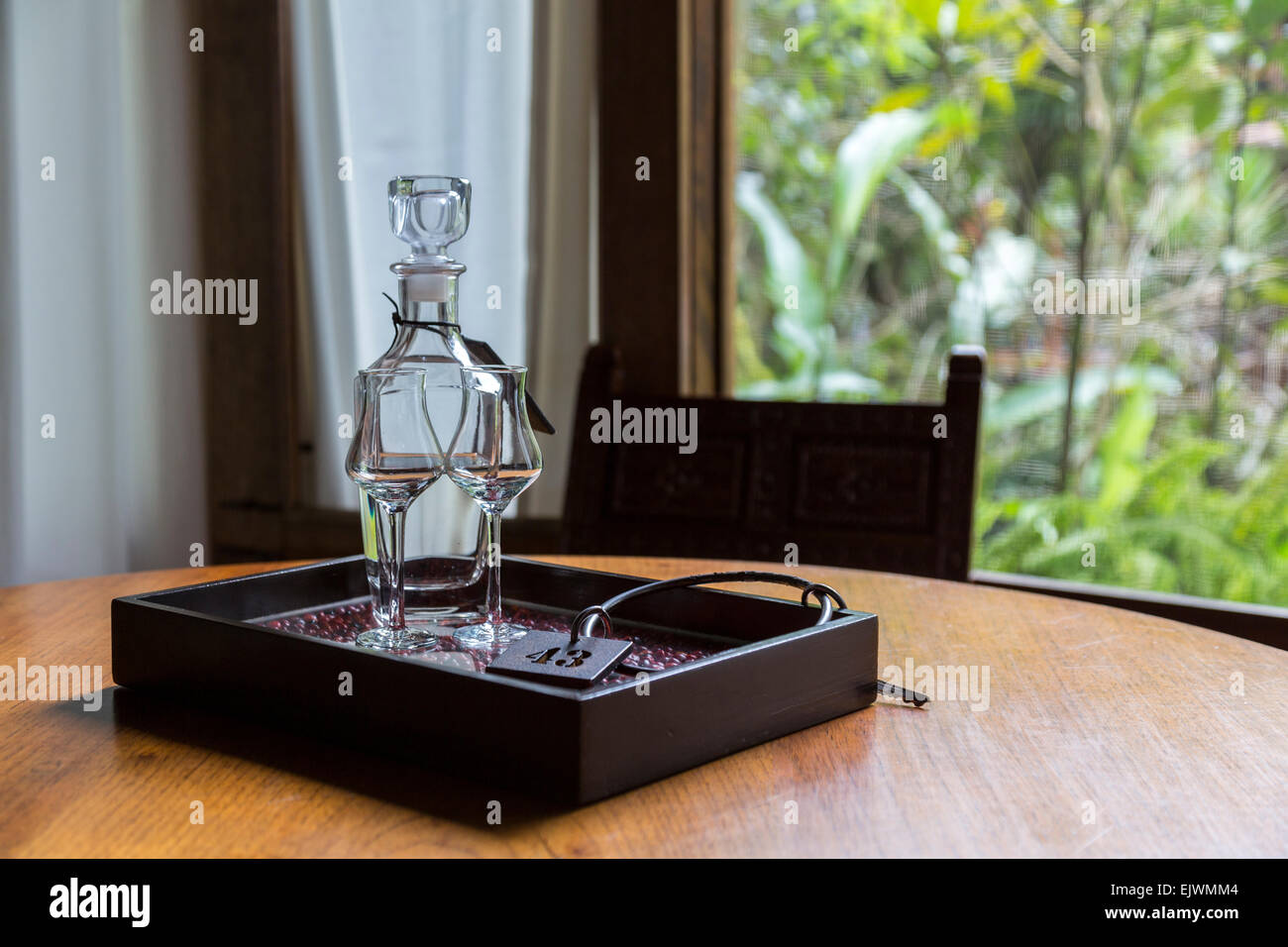 Peru, Machu Picchu Pueblo.  Pisco Brandy in Decanter with Glasses and Room Key. Stock Photo