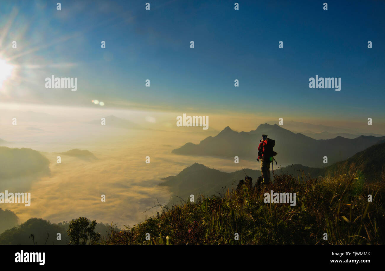 Tourist overlooking at the mists from the top of the Phu Chi Fah Mountain in Chiang Rai, Thailand Stock Photo