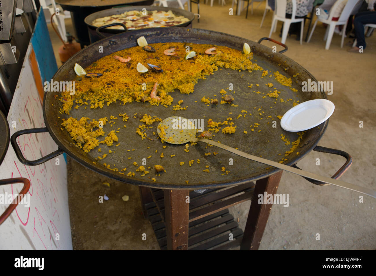 A huge paella, a Spanish traditional dish, at the Cordoba fair, Spain, in the old-fashioned way Stock Photo