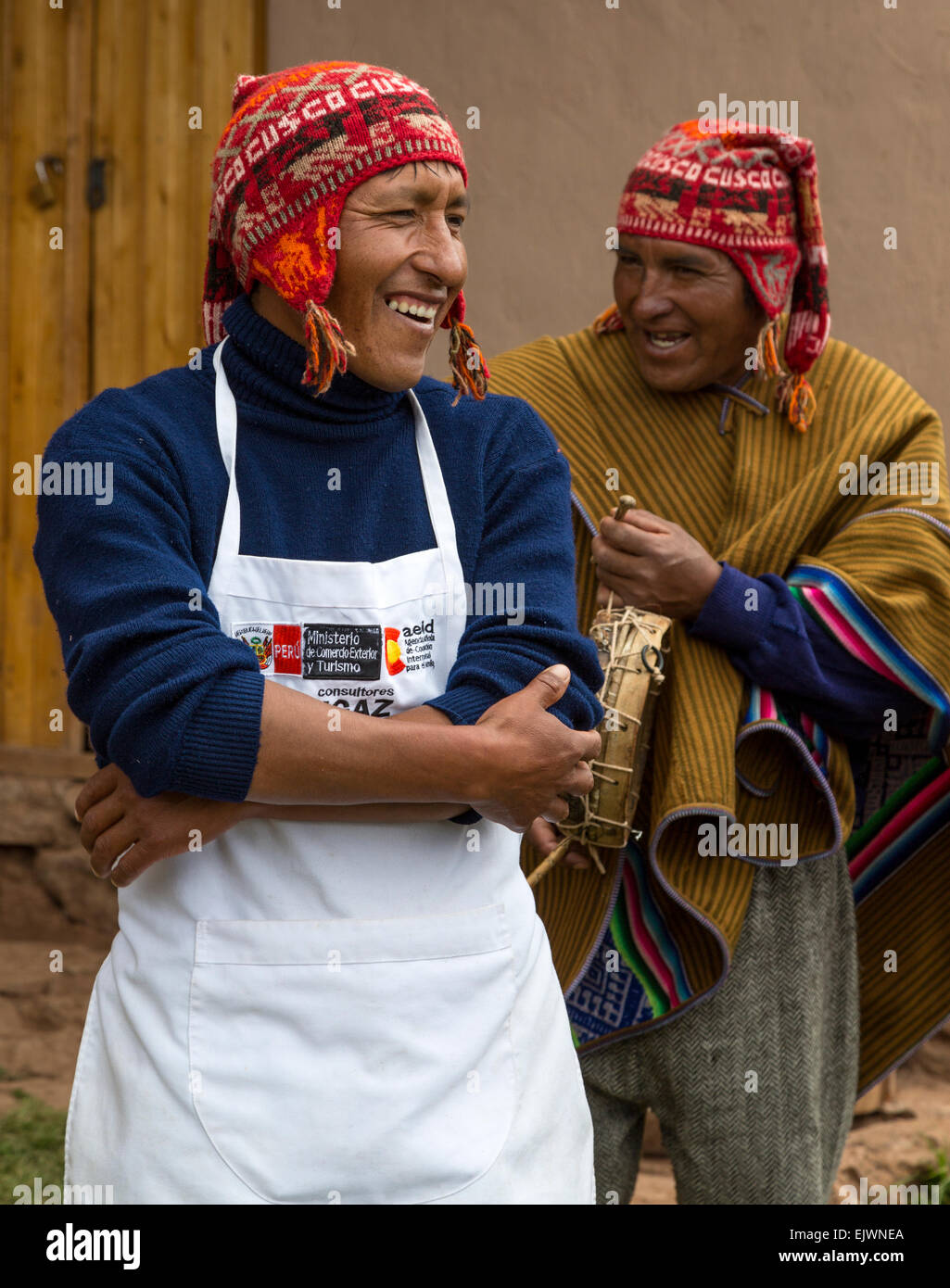 Peru, Urubamba Valley, Quechua Village of Misminay.  Two Men Talking.  The one wearing the apron is a chef. Stock Photo