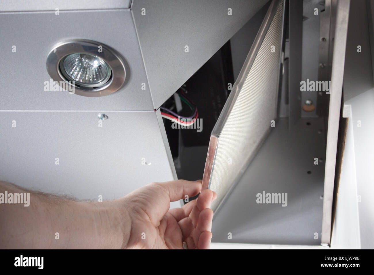 Opening a kitchen range hood vent panel Stock Photo
