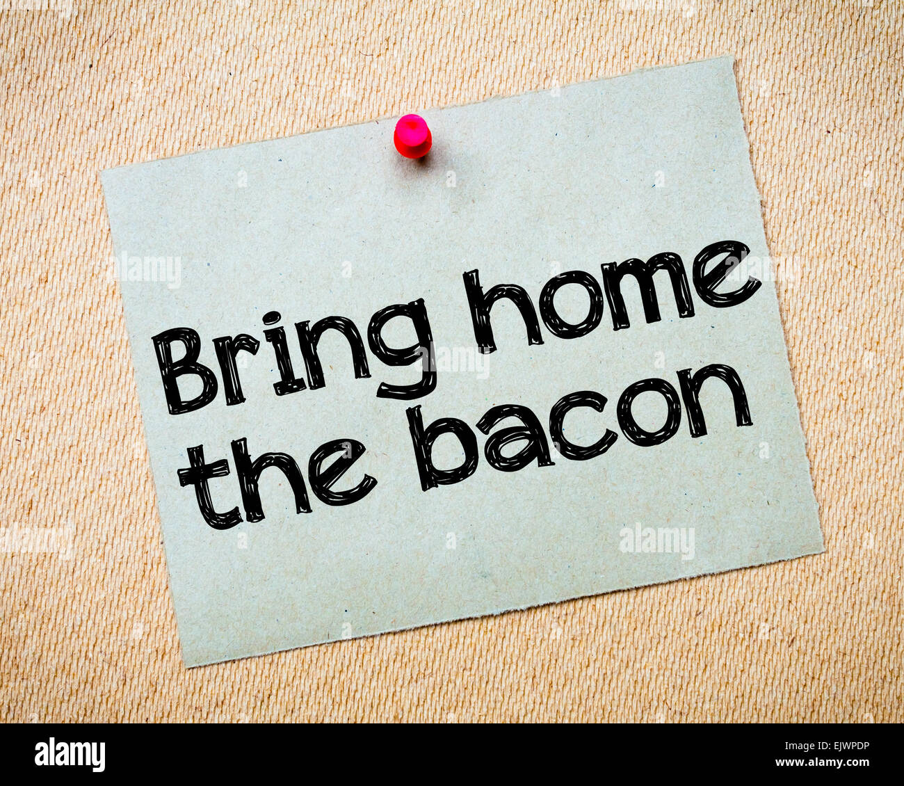 Bring home the bacon Message. Recycled paper note pinned on cork board