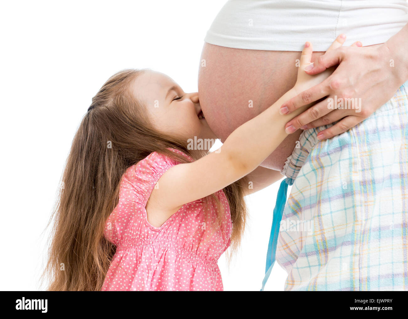 child girl kissing pregnant mother stomach Stock Photo