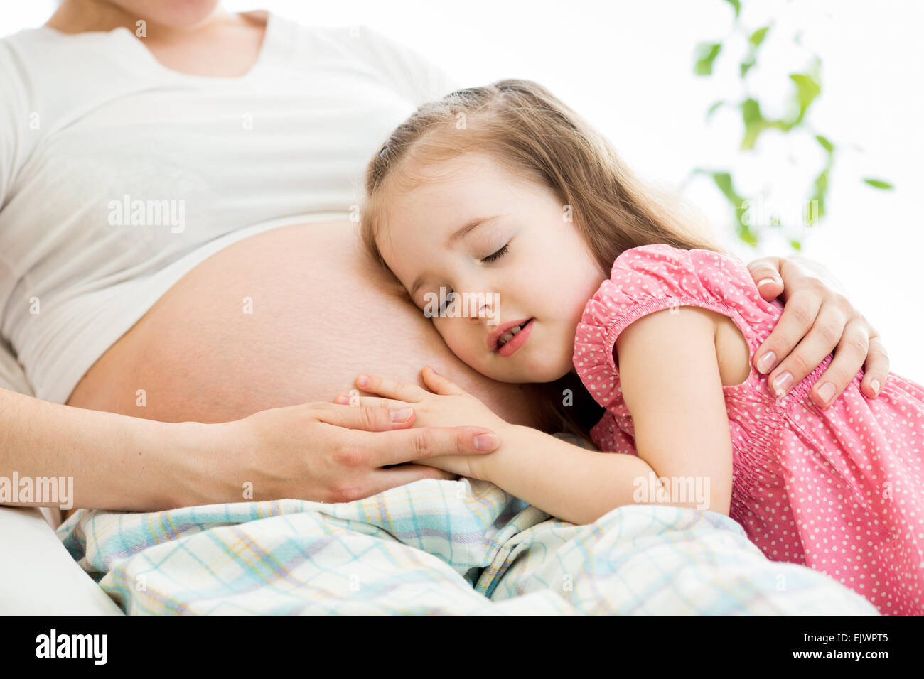 Cute child girl embracing pregnant mother Stock Photo