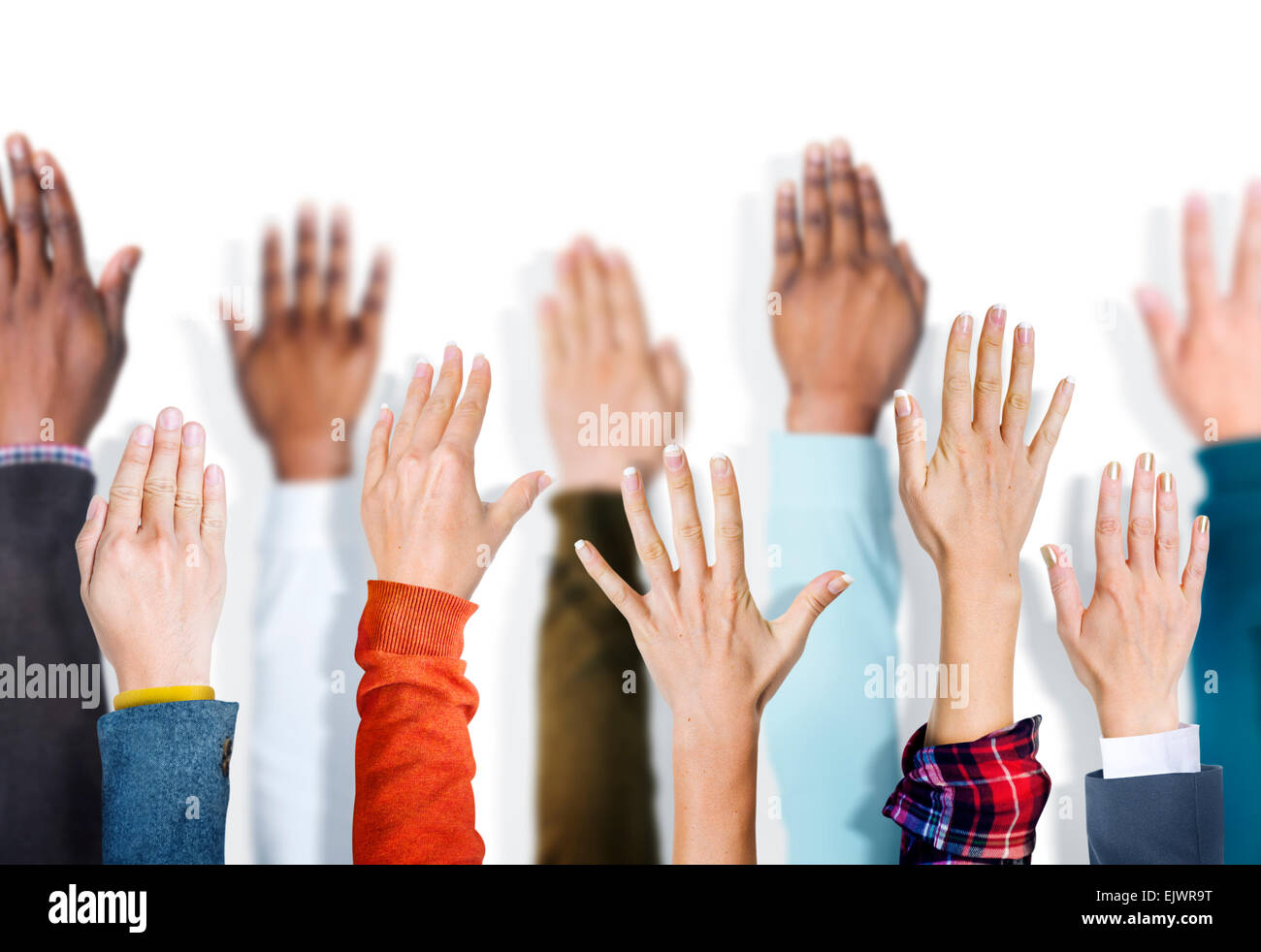 Multiethnic Group of Hands Raised Stock Photo