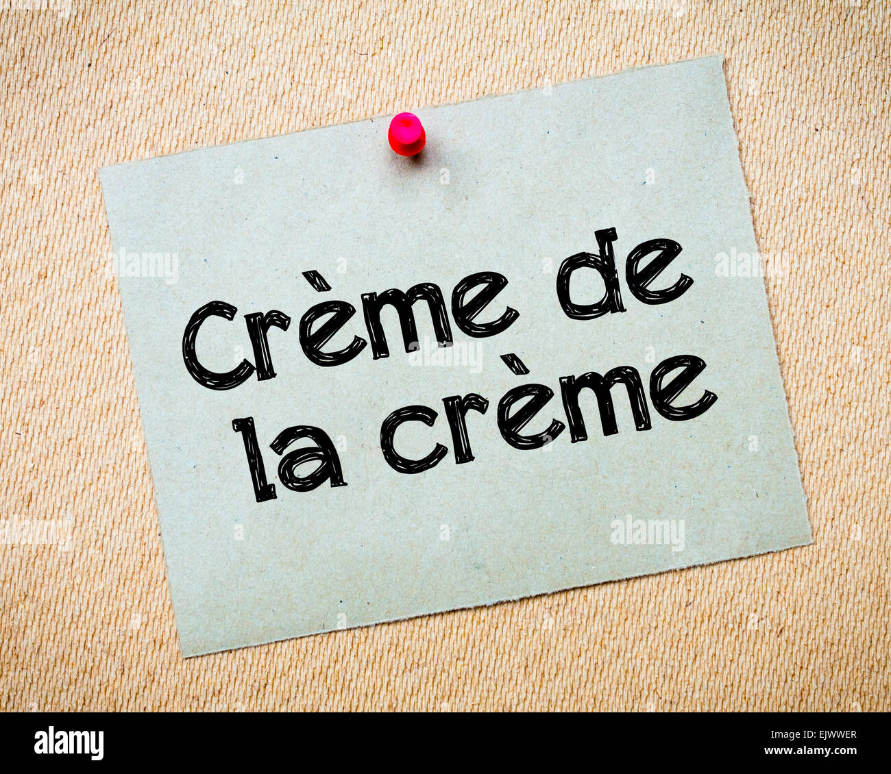 Creme de la creme Message. Recycled paper note pinned on cork board. Concept Image Stock Photo