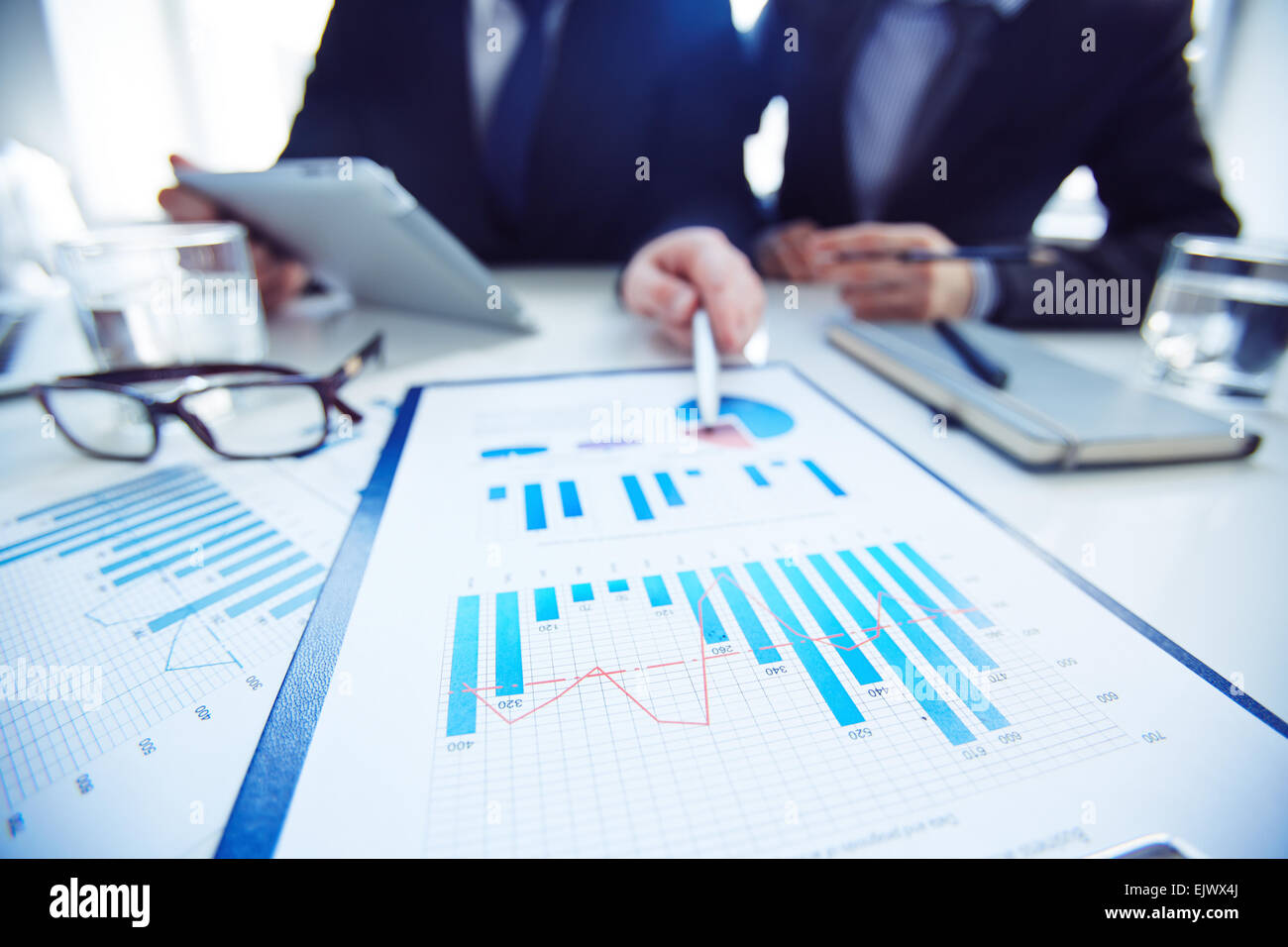 Close-up of two businessmen discussing marketing review at meeting Stock Photo