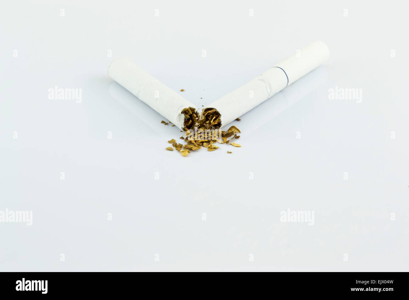 Broke cigar as a conceptual image about the will to quit the habit of smoking Stock Photo