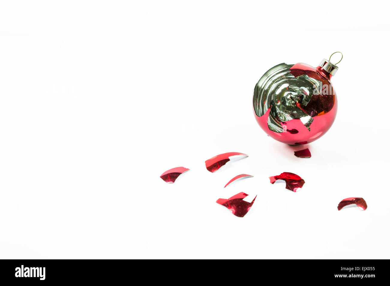 Christmas red glass ball broken with scattered shards, on white background Stock Photo