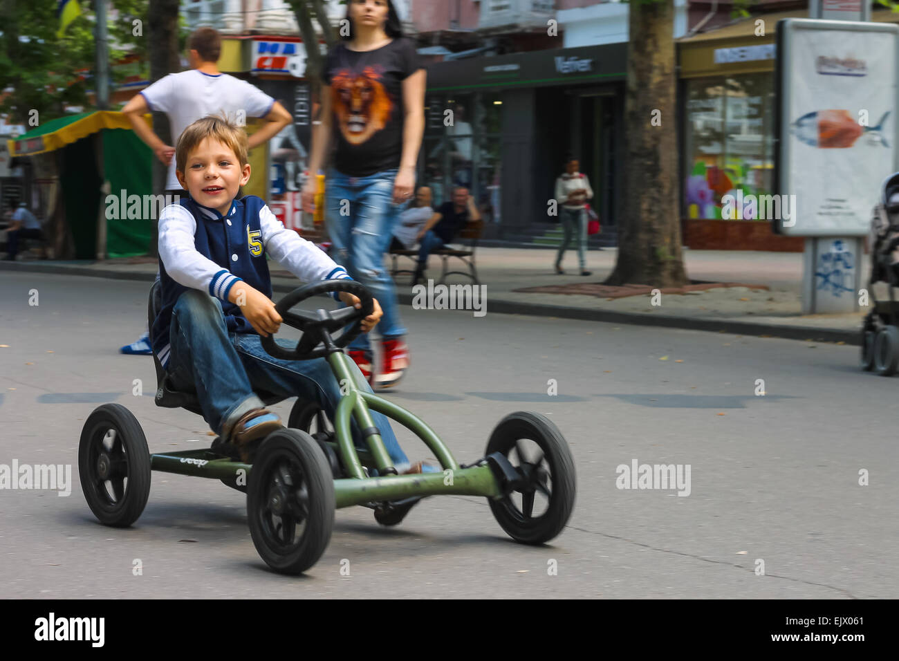 NIKOLAEV, UKRAINE - June 21, 2014: Kid in the play area riding a toy car Stock Photo