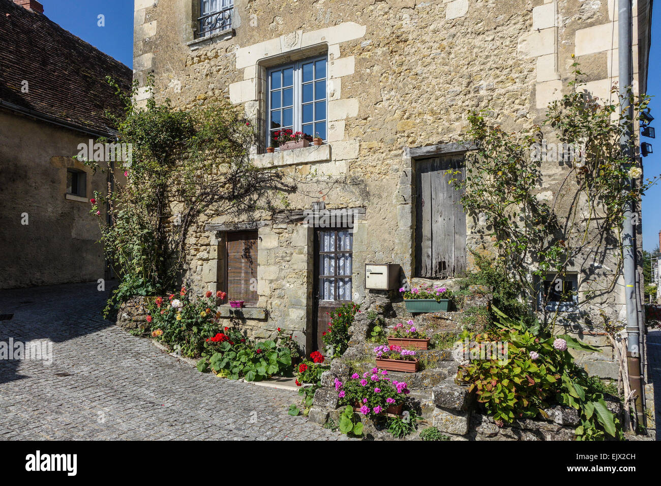 Chateau Montrésor, and the village in the Loire Vally, France. Quaint village street with flowers Stock Photo