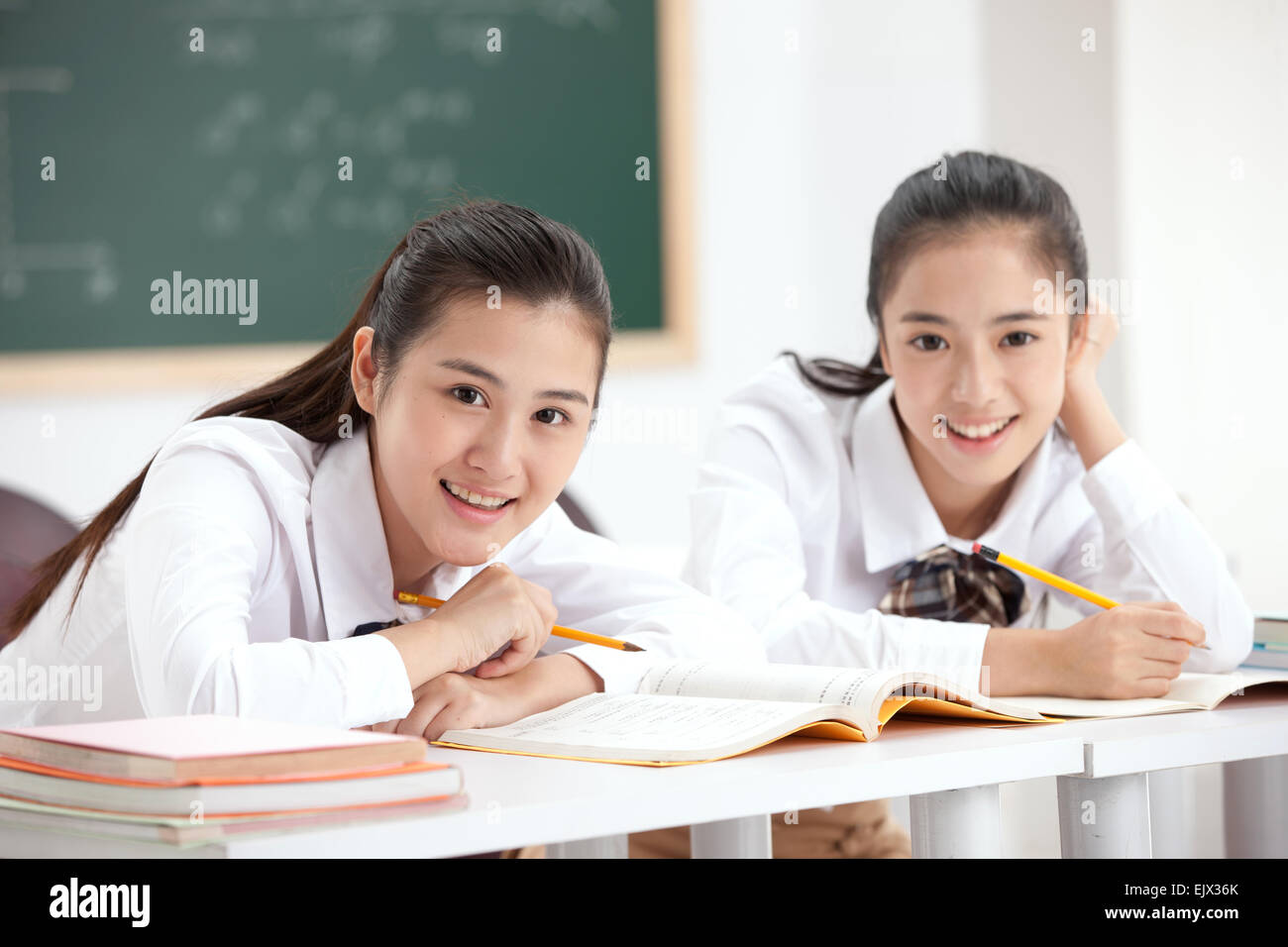 Two high school girls learn in the classroom Stock Photo