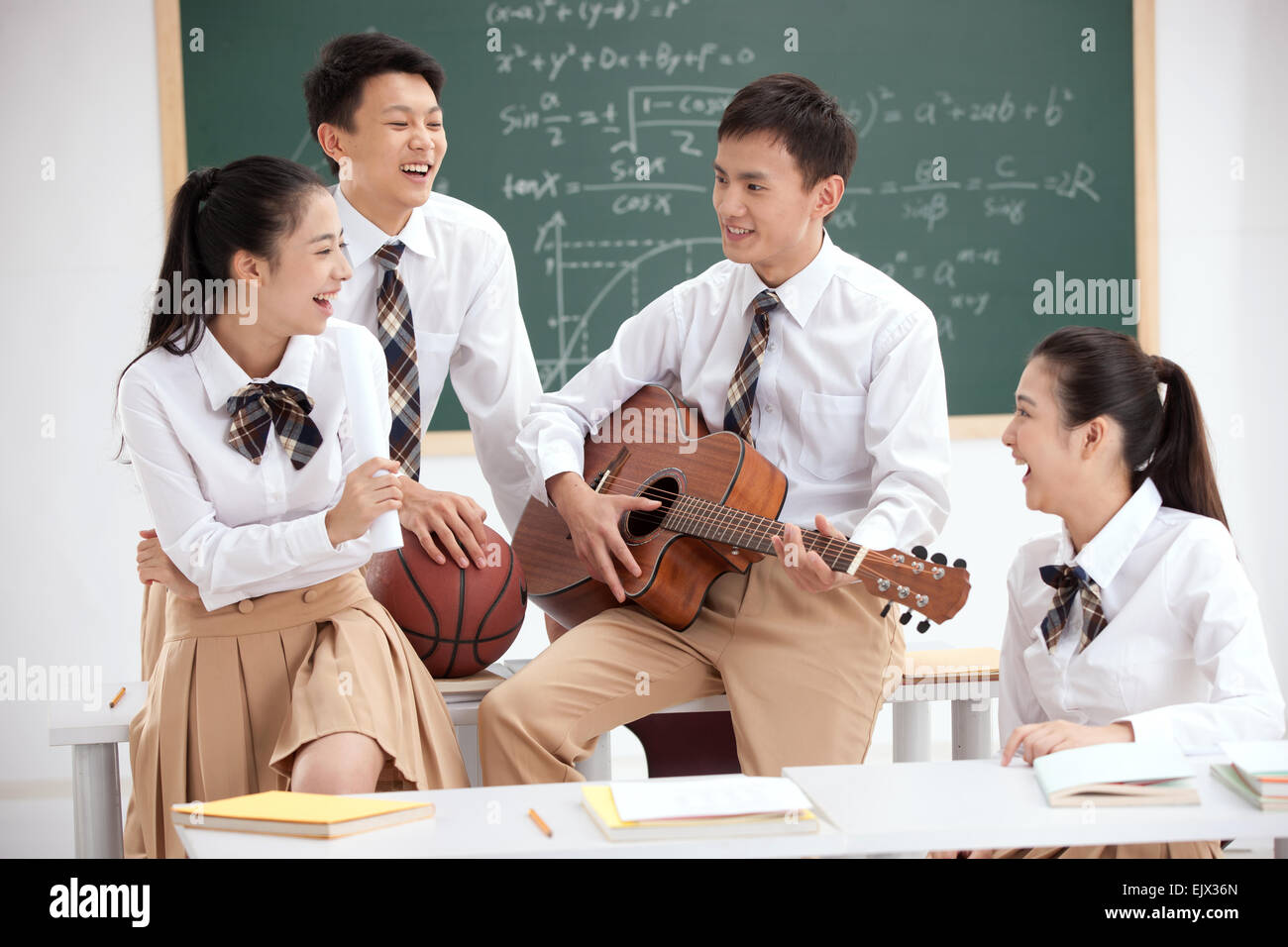 High school students with a guitar in the classroom Stock Photo Alamy