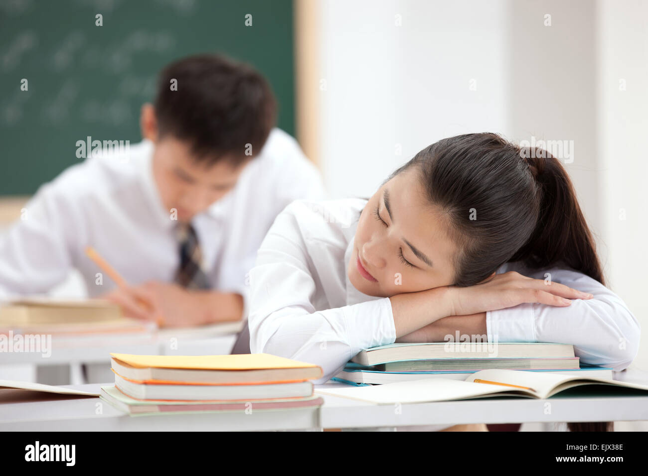 High school students rest on the desk in the classroom Stock Photo