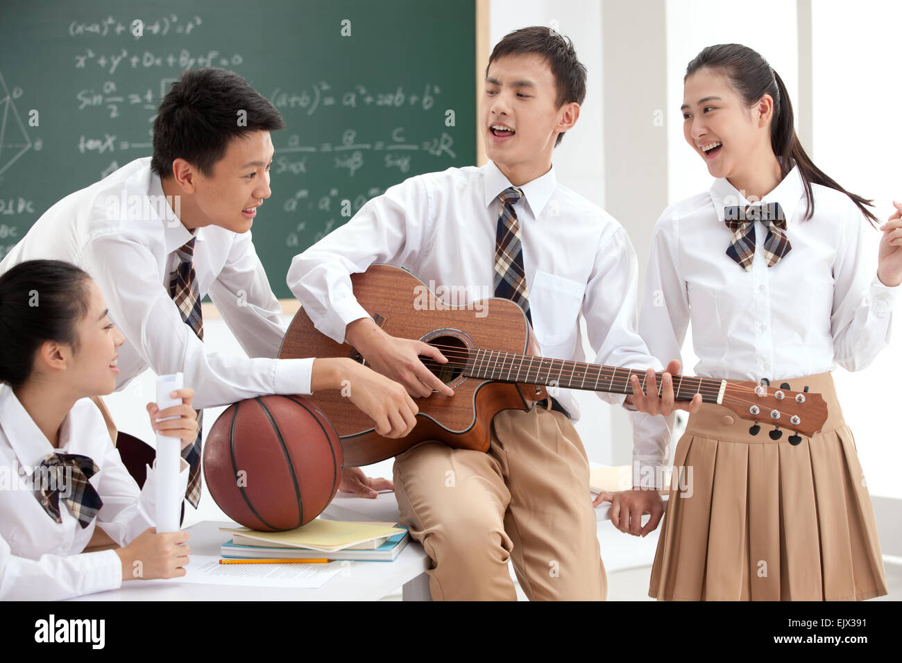 High school students to play the guitar in the classroom Stock Photo
