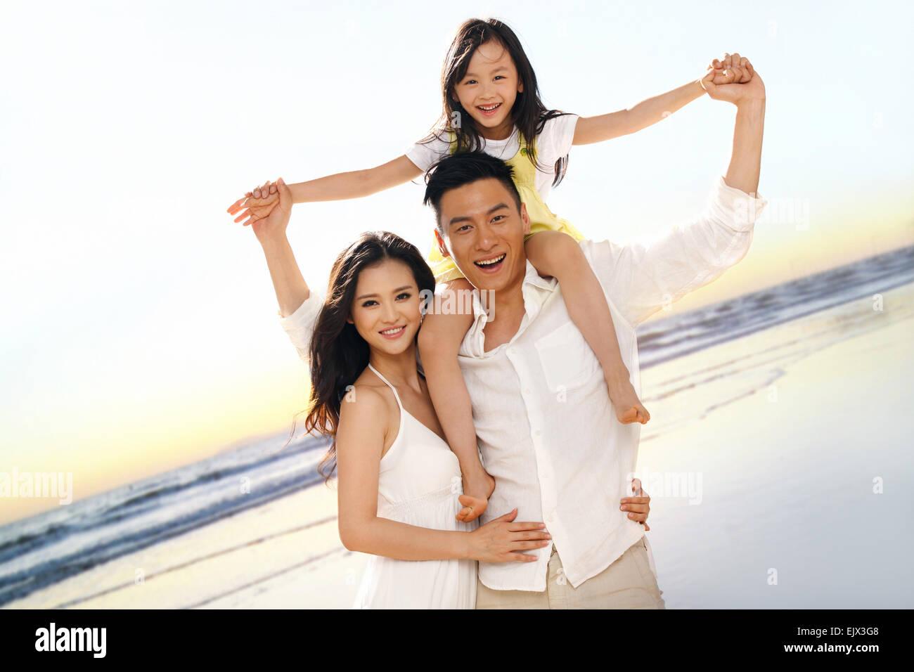 Young asian family on the beach hi-res stock photography and images - Alamy